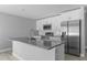 Modern kitchen featuring granite countertops, white cabinetry, and stainless steel appliances at 4495 Eldron Ave, North Port, FL 34286