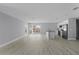 Spacious living area featuring wood-look floors, flowing into a contemporary kitchen at 4495 Eldron Ave, North Port, FL 34286