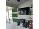 Sunroom with TV, bar area, and artificial greenery at 5519 Turtle Crossing Loop, Tampa, FL 33625