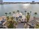 Aerial view of waterfront home with palm trees and a large driveway at 7801 9Th S Ave, St Petersburg, FL 33707