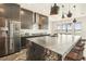 Modern kitchen with large island, dark cabinetry, and stainless steel appliances at 7801 9Th S Ave, St Petersburg, FL 33707