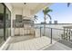 Outdoor kitchen with grill, refrigerator, and water views at 7801 9Th S Ave, St Petersburg, FL 33707