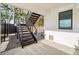 Modern metal staircase leading to the backyard and waterfront at 7801 9Th S Ave, St Petersburg, FL 33707