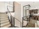 Modern staircase with glass and metal railing and wine cellar feature at 7801 9Th S Ave, St Petersburg, FL 33707