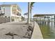 View of home's exterior and backyard with boat lift at 7801 9Th S Ave, St Petersburg, FL 33707