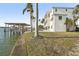 Side yard view of home with boat lift and waterfront access at 7801 9Th S Ave, St Petersburg, FL 33707