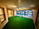Enclosed patio with pool view and artificial turf flooring at 12010 Villa Rd, Spring Hill, FL 34609