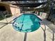 Refreshing kidney-shaped pool with screened enclosure at 12010 Villa Rd, Spring Hill, FL 34609