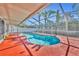 Kidney-shaped pool with screened enclosure at 304 Tavernier Dr, Oldsmar, FL 34677