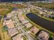 Aerial view of a luxury community with lakefront homes and lush landscaping at 33161 Kateland Dr, Wesley Chapel, FL 33545