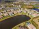 Aerial view of upscale homes surrounding a peaceful lake at 33161 Kateland Dr, Wesley Chapel, FL 33545