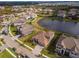 Aerial view shows a luxury home near a lake in a residential community at 33161 Kateland Dr, Wesley Chapel, FL 33545