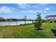 Landscaped backyard with lake view at 33161 Kateland Dr, Wesley Chapel, FL 33545