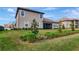 Landscaped backyard with screened patio at 33161 Kateland Dr, Wesley Chapel, FL 33545