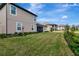 Landscaped backyard with neighboring homes at 33161 Kateland Dr, Wesley Chapel, FL 33545