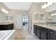 Large bathroom with double vanity, and a view into the bedroom at 33161 Kateland Dr, Wesley Chapel, FL 33545