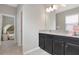 Bathroom with granite countertop and dark brown cabinets at 33161 Kateland Dr, Wesley Chapel, FL 33545