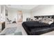 Main bedroom with king-size bed, exercise bike and access to other rooms at 33161 Kateland Dr, Wesley Chapel, FL 33545