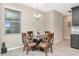 Charming breakfast nook with glass table and four chairs at 33161 Kateland Dr, Wesley Chapel, FL 33545