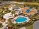 Resort-style community pool with playground and shaded seating at 33161 Kateland Dr, Wesley Chapel, FL 33545
