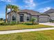 Two-story house with a three-car garage and a well-manicured lawn at 33161 Kateland Dr, Wesley Chapel, FL 33545