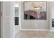 Elegant hallway with large art piece and view of bathroom at 33161 Kateland Dr, Wesley Chapel, FL 33545