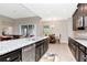 Modern kitchen with dark wood cabinets, granite countertops, and stainless steel appliances at 33161 Kateland Dr, Wesley Chapel, FL 33545