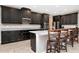 Modern kitchen with island, dark cabinets, and granite countertops at 33161 Kateland Dr, Wesley Chapel, FL 33545