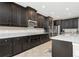 Modern kitchen with dark wood cabinets and granite countertops at 33161 Kateland Dr, Wesley Chapel, FL 33545