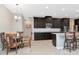Modern kitchen with dark wood cabinets and granite countertops at 33161 Kateland Dr, Wesley Chapel, FL 33545