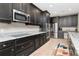 Spacious kitchen featuring dark cabinetry and granite countertops at 33161 Kateland Dr, Wesley Chapel, FL 33545