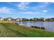 Serene lakefront view of homes and landscape at 33161 Kateland Dr, Wesley Chapel, FL 33545