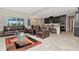 Spacious living room with leather furniture, open concept to kitchen at 33161 Kateland Dr, Wesley Chapel, FL 33545