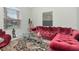 Living room with tufted red velvet sectional sofa at 33161 Kateland Dr, Wesley Chapel, FL 33545