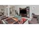 Living room with leather sofas, a coffee table, and an entertainment center at 33161 Kateland Dr, Wesley Chapel, FL 33545
