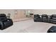 Spacious rec room with leather recliners and built-in cabinets at 33161 Kateland Dr, Wesley Chapel, FL 33545