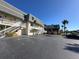 Building exterior with parking lot and palm trees at 12465 2Nd E St # 103, St Petersburg, FL 33706