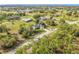 Aerial image of a single Gathering home in a residential neighborhood near a lake at 16760 Acapulco Rd, Punta Gorda, FL 33955