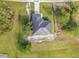 Aerial view of the new home with manicured landscaping, dark metal roof, and brick driveway at 16760 Acapulco Rd, Punta Gorda, FL 33955