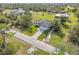 An aerial view of a house with a dark roof, white exterior, and a paver driveway at 16760 Acapulco Rd, Punta Gorda, FL 33955