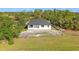 Aerial view of the home displaying its metal roof, covered patio, and expansive lot at 16760 Acapulco Rd, Punta Gorda, FL 33955