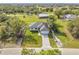 New home with a gray roof, lush green lawn and stone paver driveway in a pastoral neighborhood at 16760 Acapulco Rd, Punta Gorda, FL 33955