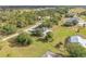 Quaint single-Gathering home on a sprawling lot surrounded by trees, grass, and an asphalt road at 16760 Acapulco Rd, Punta Gorda, FL 33955