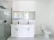 Modern bathroom featuring a double sink vanity, framed mirrors, sleek fixtures, and a glass-enclosed shower at 16760 Acapulco Rd, Punta Gorda, FL 33955