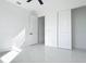 Bright bedroom featuring sleek tile flooring, a doorway to an adjacent room and sliding closet doors at 16760 Acapulco Rd, Punta Gorda, FL 33955