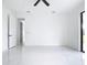 Bright bedroom featuring a ceiling fan, open doorways, and marble floors at 16760 Acapulco Rd, Punta Gorda, FL 33955
