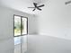 Bright bedroom featuring sleek tile flooring, a sliding glass door and plenty of natural light at 16760 Acapulco Rd, Punta Gorda, FL 33955