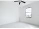 Bright bedroom features a ceiling fan and a large window view at 16760 Acapulco Rd, Punta Gorda, FL 33955