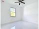 Bright bedroom features a ceiling fan and an exterior view from the window at 16760 Acapulco Rd, Punta Gorda, FL 33955