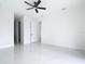 Bright bedroom featuring a ceiling fan, open doorways, and marble floors at 16760 Acapulco Rd, Punta Gorda, FL 33955